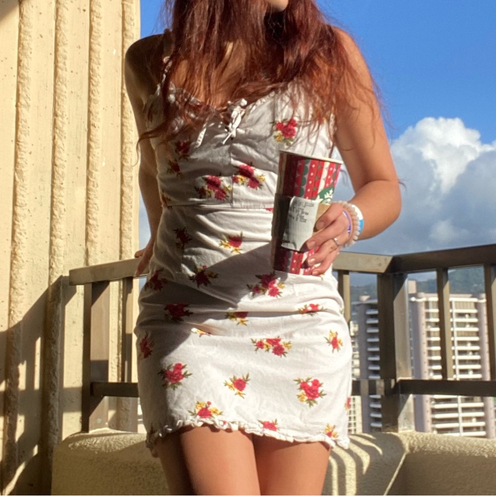 White form fitting dress with flowers on it
